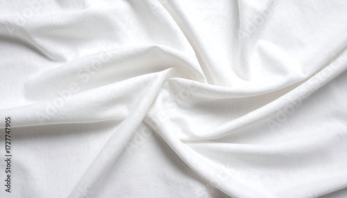 Close-up of softly lit white fabric, draped and folded with varying depths of shadows