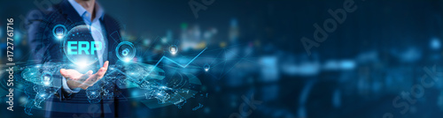 Businessman hand hold of ERP and global networking. enterprise resource planning platforms, integrated business management systems, cloud-enabled operational efficiency frameworks.