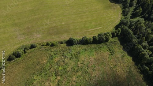 farmers' agricultural green fields and processing areas filmed from above with drones