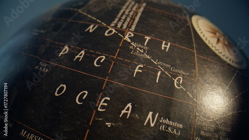 Pacific ocean marked globe dark surface closeup zoom out. Vintage Earth model 