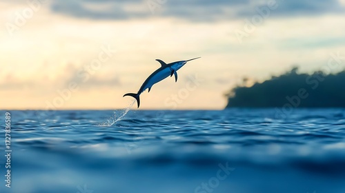 A majestic marlin leaps from the ocean surface at sunrise, showcasing its power and grace