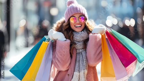 happy woman holding colorful shopping bags
