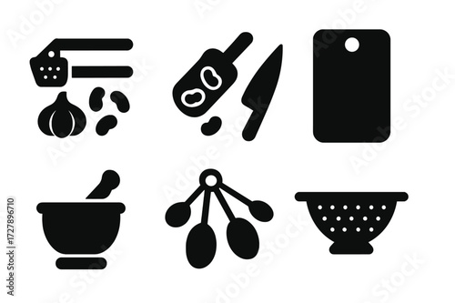 Garlic and Beans Tools. Solid, filled icon set of garlic and beans kitchen tools: garlic press, bean scoop, knife, cutting board, mortar and pestle, measuring