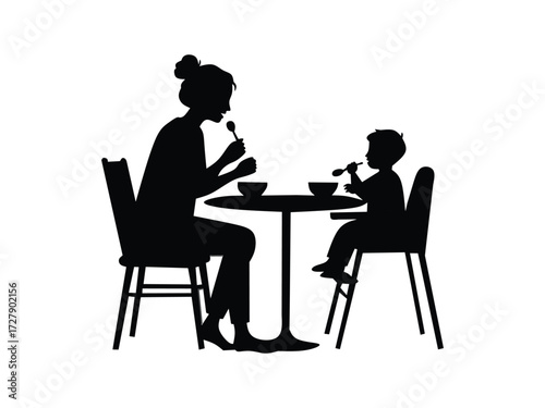 silhouette of mother and child eating together