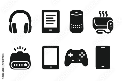 Comfort Tech Icons. Solid, filled icon set of comfort technology: headphones, e-reader, smart speaker, blanket heater, sound machine, tablet, gaming
