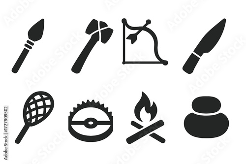 Tribal Tool Icons. Solid, filled icon set of tribal tools: spearhead, axe, bow and arrow, knife, fishing net, trap, firestarter, grinding stone. Solid, filled