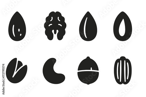 Nut and Seed Icons. Solid, filled icon set of hand-picked nuts and seeds: almond, walnut, sunflower seed, pumpkin seed, pistachio, cashew, hazelnut, pecan.
