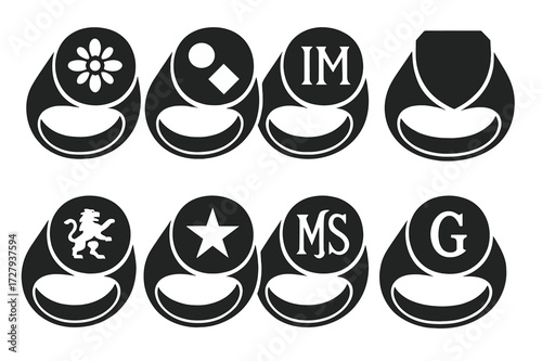 Engraved Ring Icon Set. Solid, filled icon set of engraved ring faces: floral pattern, geometric shapes, initials, family crest, shield, animal motif, star