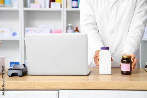 Female pharmacist with pill...