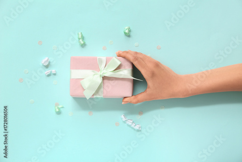 Female hand with pink gift ...