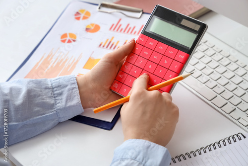Female accountant with calc...