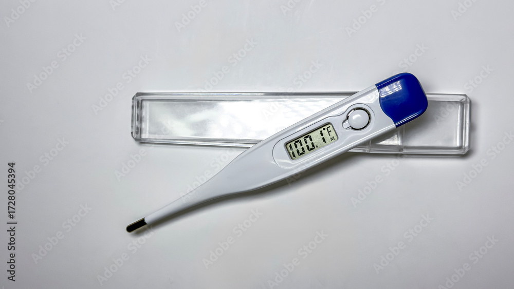 Obraz premium Digital medical thermometer with blue cap isolated on white background