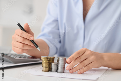 Businesswoman with stacks o...