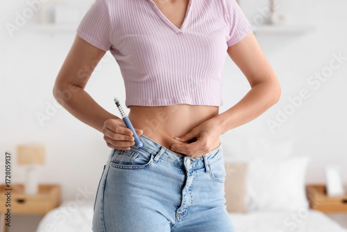 Woman with syringe of IVF h...