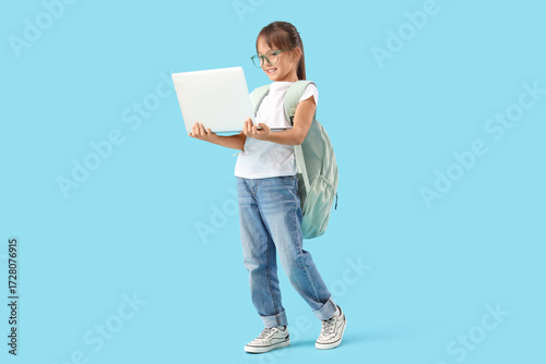 Cute little schoolgirl with...
