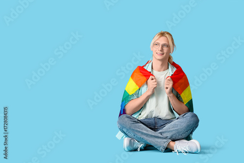 Young man with LGBT flag si...