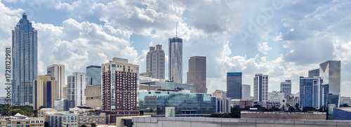 View of the Midtown, Downtown Atlanta Skyline showing several prominent buildings, and hotels under a cloudy  sky.