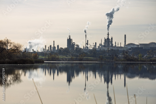 Oil refinery reflected in lake