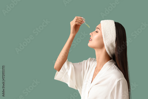 Young woman applying facial...
