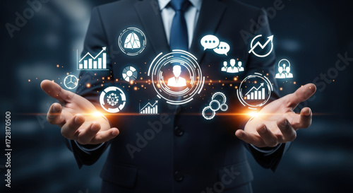 Businessman Holding Digital Network of Business Icons and Analytics.