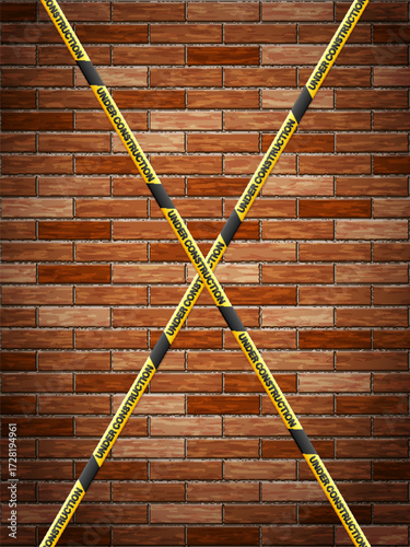 Under construction tape on bricks background