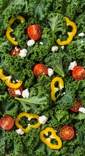 Fresh kale salad with tomatoes, yellow pepper, and feta cheese for a healthy lunch or dinner