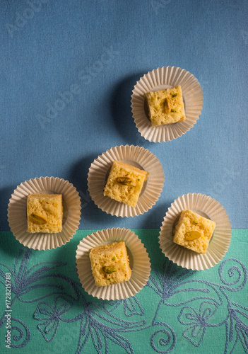Delicious Mysore paak- a traditional Indian sweet or dessert presented on a paper cups. Sweet made with simple ingredients like ghee, besan and sugar. 