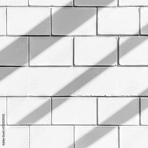 White brick wall with diagonal sunlight shadows