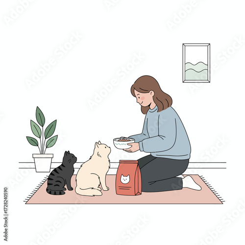 A young woman kneels on a rug, kindly feeding her two adorable cats from a bowl at home.