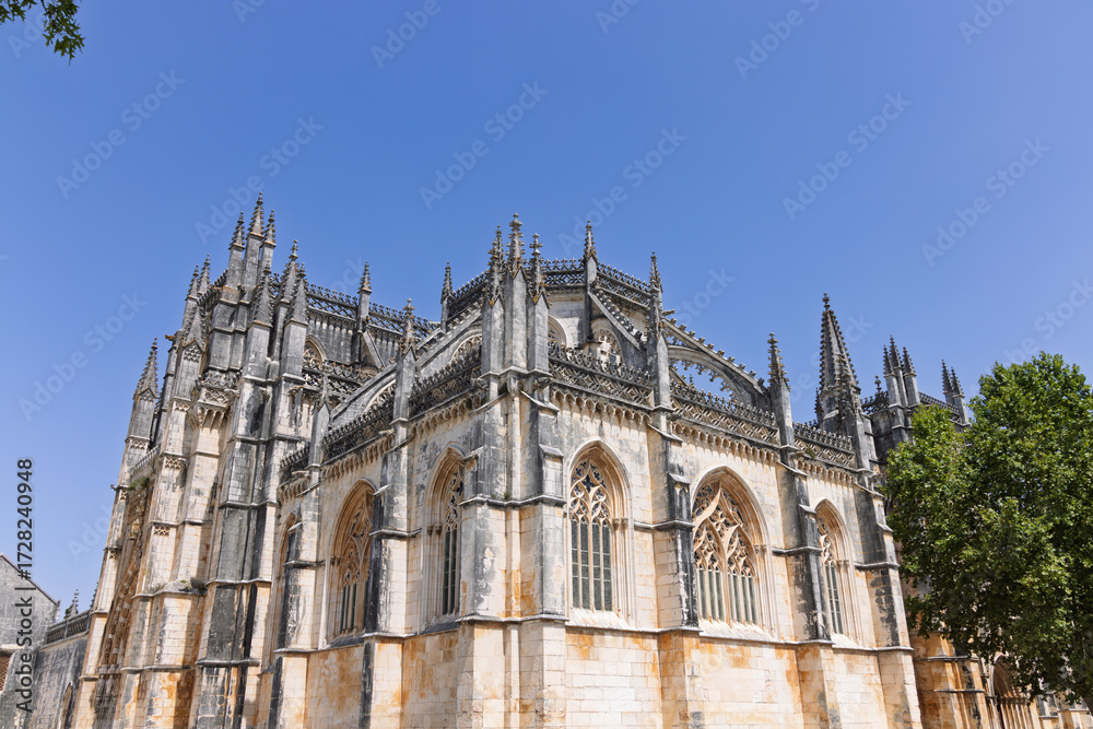 Fototapeta premium The stunning Manueline arcades and Gothic tracery of the Royal Cloister (Claustro Real) at Batalha Monastery. Peaceful Portuguese heritage.
