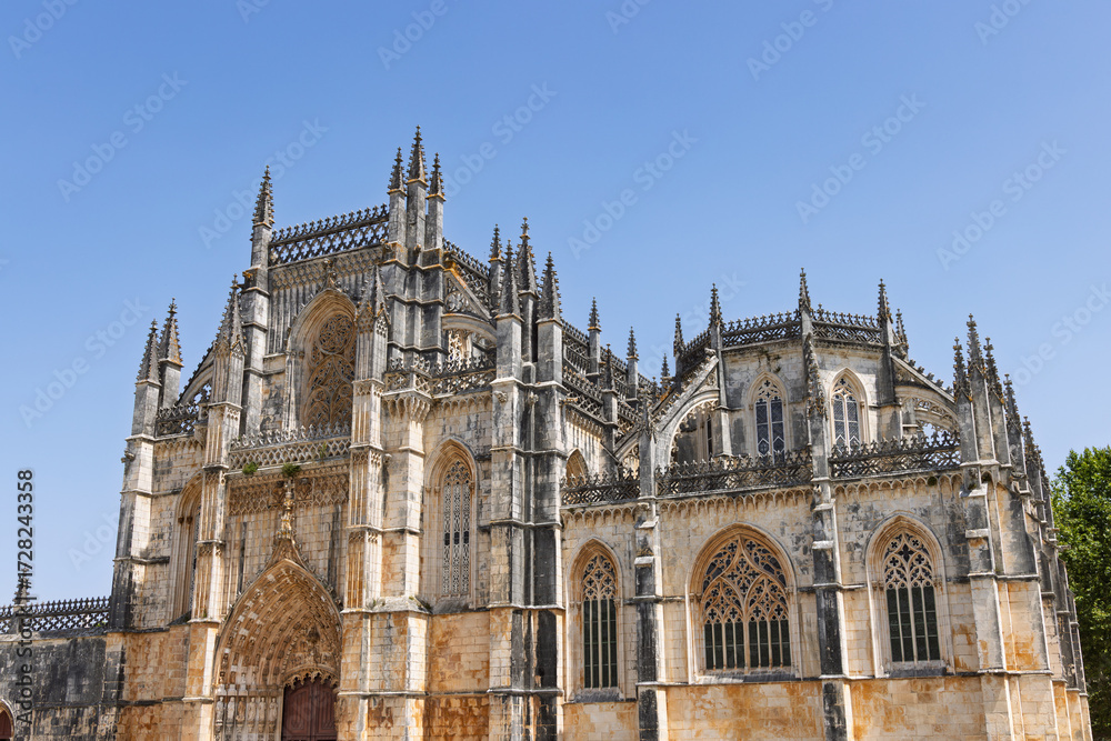Fototapeta premium The stunning Manueline arcades and Gothic tracery of the Royal Cloister (Claustro Real) at Batalha Monastery. Peaceful Portuguese heritage.