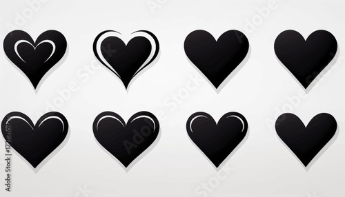 A collection of eight different black heart icons in various graphic styles on a light background.