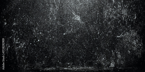 A dark grayish-black color palette, resembling weathered concrete or a distressed wall, The texture is rough and uneven, with subtle variations in shade and scattered light speckles.