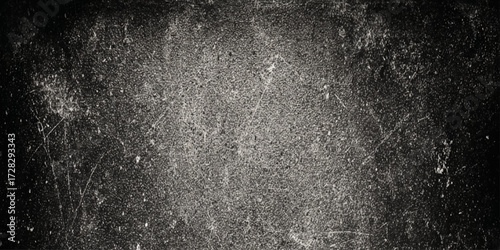 A textured surface with a dark, gritty appearance, resembling a weathered or scratched material such as old metal or painted wall, dark gray, with a rough, uneven texture featuring scattered.