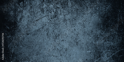 A textured surface with a dark, gritty appearance, resembling a weathered or scratched material such as old metal or painted wall, dark gray, with a rough, uneven texture featuring scattered.