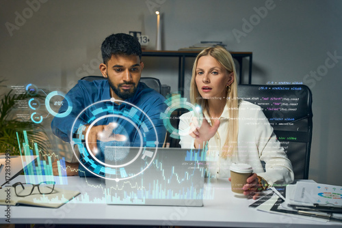 Team Of Data Analysts Collaborating With Holographic Interface And Digital Analytics In Office Workspace Environment