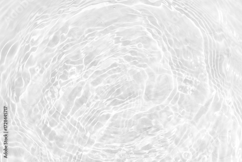 White water with ripples on the surface. Defocus blurred transparent white colored clear calm water surface texture with splashes and bubbles. Water waves with shining pattern texture background.
