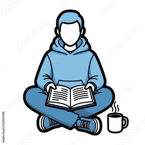 Young person sitting crosslegged wearing blue hoodie, reading an open book with steaming cup coffee on the side
