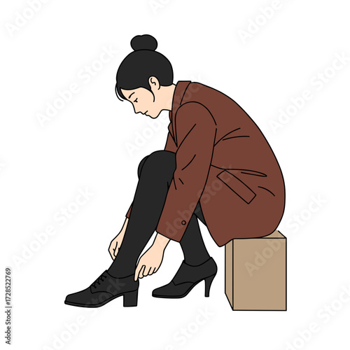 Young woman sitting on box while putting on high heel shoes  