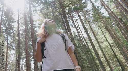 Bottom shot of a young woman backpacker in a summer forest