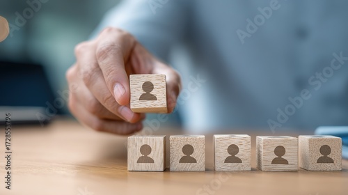 Hand Placing Business Person Wooden Block - Team Formation and Talent Allocation