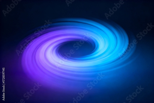 Abstract swirling vortex of blue and purple light against a dark background