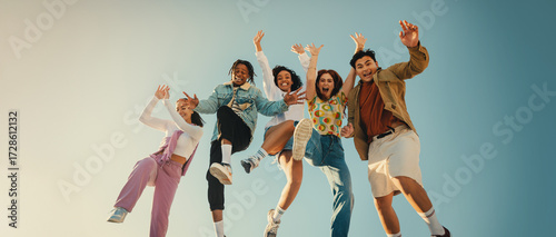 Фотография Group of friends laughing and jumping outdoors