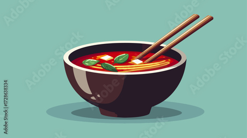 Bowl of red soup with chopsticks