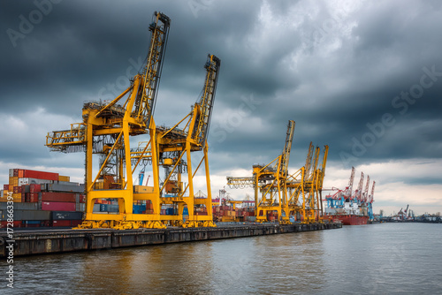 Industrial shipping port with large yellow cranes and stacked cargo containers