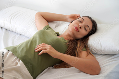Quadro em tela Beautiful young woman sleeping lying on bed comfortably and blissfully