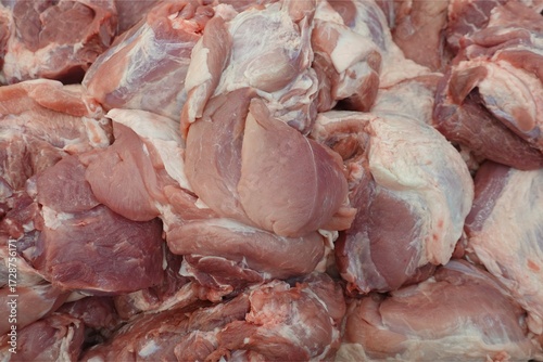 Close-up of Fresh Raw Pork Meat Cuts Piled in a Butcher Shop.	