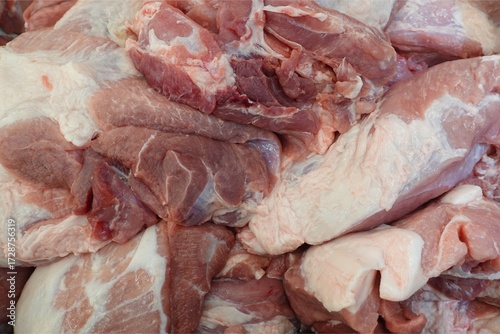 Close-up View of Fresh Raw Pork Meat Cuts Piled in a Butcher Shop or Market.	