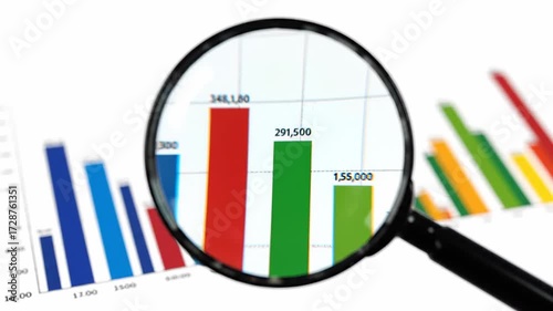 Magnifying glass zooming in on a data chart displaying fluctuating statistics. Concept related to business, finance, and marketing on a clean white backdrop