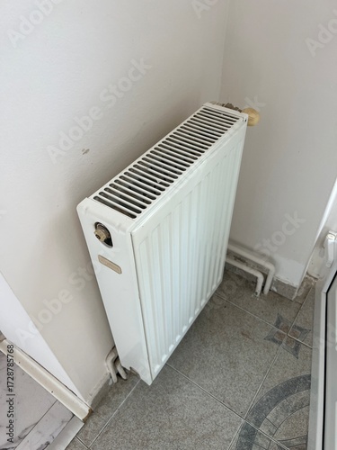 Wallpaper Mural White heating radiator near a wall, ready for the cold season. Concept of home heating, energy efficiency, and warmth in winter Torontodigital.ca